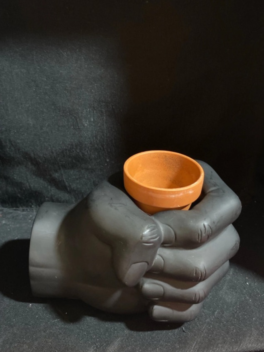 Weighted fist hand desk caddy planter with magnetic section